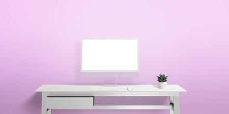 Computer display on white work desk with isolated screen for web page presentation. Pink wall with copy space in backgroundの写真素材