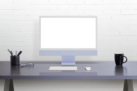 Modern computer display on office desk. Isolated screen for web page mockup promotionの写真素材