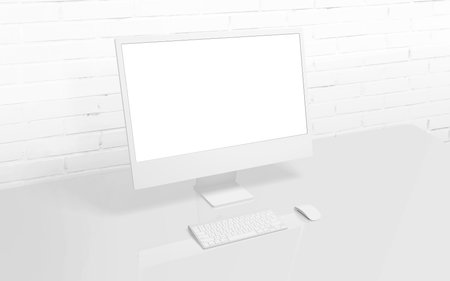 White computer display on work desk with brick wall in background. Isolated screen for mockup, app or web page presentationの写真素材