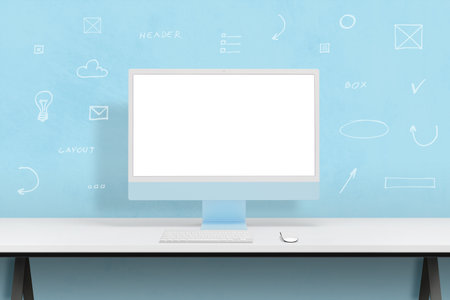 Modern blue computer display mockup surrounded by web design icons concept. Clean studio desk with blue wall in backgroundの写真素材