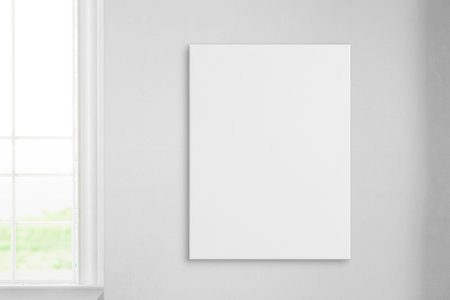 Vertical art canvas on wall beside a window. Clean surface ideal for mockup art presentation. Perfect for showcasing artwork and enhancing interior design with a touch of eleganceの写真素材