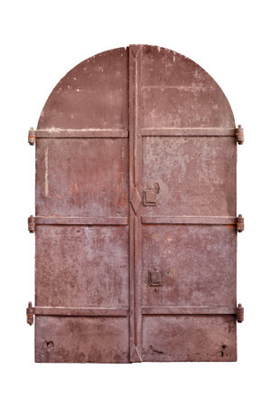 Ancient double iron doors with arched top, reinforced structure, three hinges on each side, and small peepholes, once guarding the entrance to a castle or fortressの写真素材