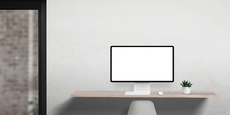 Office computer display mockup in clean and flat workspace, with a single plant on the desk and office door on the leftの写真素材