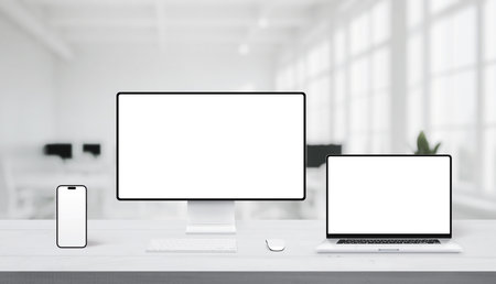 Close-up of responsive mockup with smartphone and laptop on office desk, both screens ready for UI or web designの写真素材