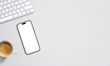 Smartphone mockup on desk with keyboard and coffee. Clean right-side space perfect for promotional text, branding, or web design conceptsの写真素材