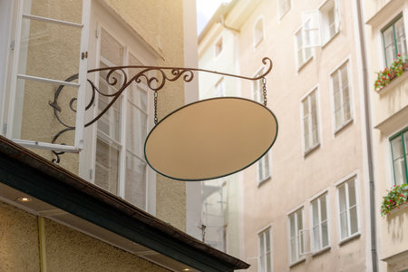Retro style empty signage board with wrought iron support, ideal for traditional business mockups, bakery or local artisan shop branding.の写真素材