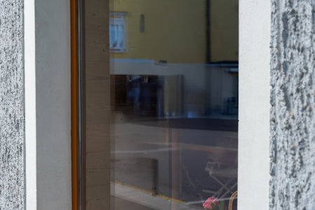 Modern store window with reflections of street and surroundings, ideal for branding mockups, advertising materials, or minimalist commercial visualsの写真素材