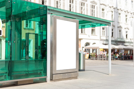 Vertical outdoor mockup at modern glass bus station with copy space, suitable for public information, ads or brandingの写真素材