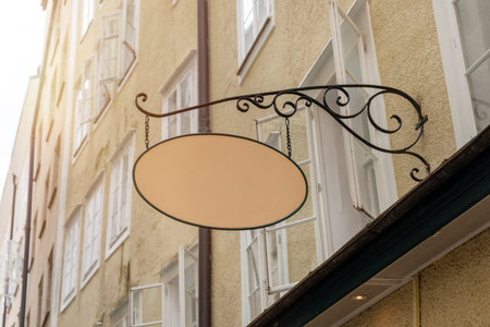 Decorative oval signage on historic building wall, suitable for boutique store visuals, cafÃ© logo templates, or artisan advertising graphicsの写真素材