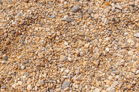 Close-up of small colorful beach pebbles and stones forming a natural textureの写真素材
