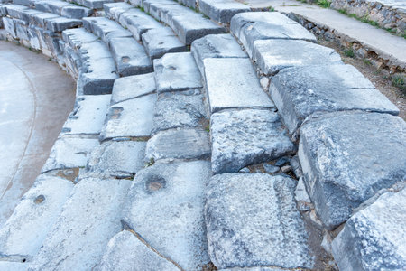 Close-up of the ancient stone seating of the theatre of Philippi, highlighting the craftsmanship and weathered textureの写真素材