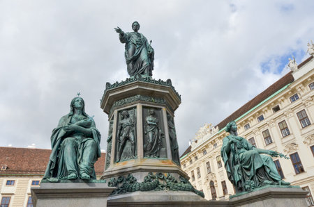 Close view of Francis I monument at Hofburg Palace with detailed bronze statues and cloudy sky in Vienna, Austria.の写真素材