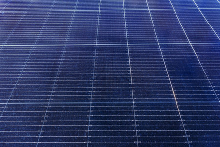 Full frame of photovoltaic solar panels showing geometric pattern and dark blue reflective surfaceの写真素材