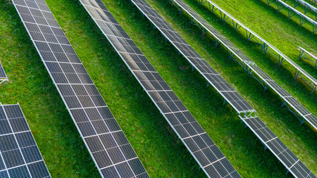 Metal structures for solar panels installation on grassy field under sunlightの写真素材