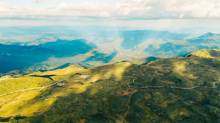 Vast green mountain range under summer lightの写真素材