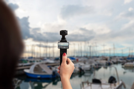 Handheld camera recording marina with boats, concept of travel, vlog, sea lifestyle and explorationの写真素材