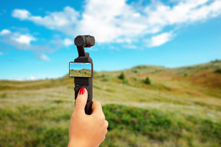 Handheld camera recording scenic mountain landscape under blue sky, concept of travel, exploration, adventure and creativityの写真素材