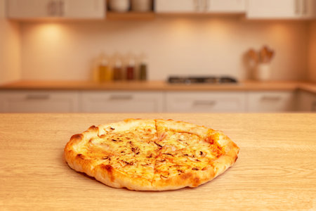 Cheese pizza on wooden table with orange background, minimal composition and warm light emphasizing texture of crustの写真素材