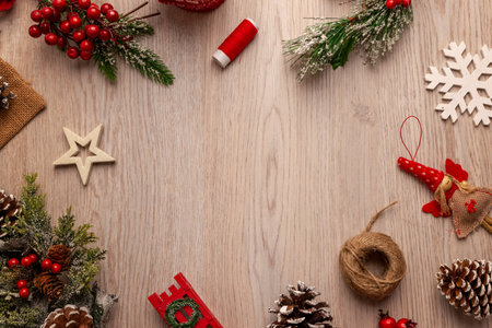Festive Christmas background with natural decorations on wooden surface, perfect for website headers, banners, greetings and winter holiday layoutsの写真素材