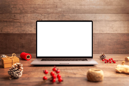 Laptop with blank white screen in Christmas flat lay environment, ideal for website mockups, holiday marketing, product previews and seasonal digital presentationsの写真素材