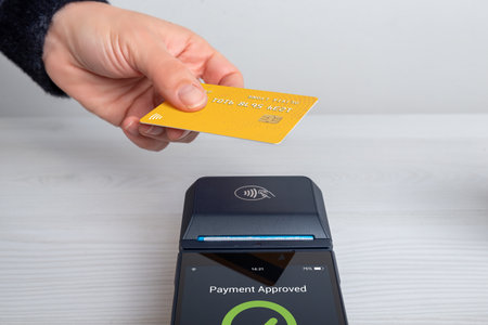 Contactless card payment approved on POS terminal, showing successful transaction confirmation and modern cashless payment technologyの写真素材