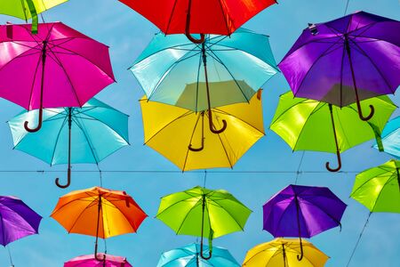 Looking up at the colorful umbrellas. Festive street decoration.の写真素材