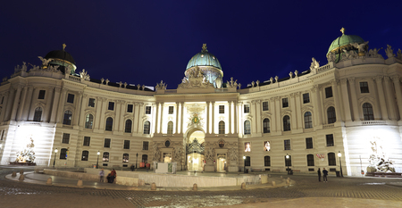 View of Hofburg illuminated at dusk, the imperial palace of the Habsburgs, from Michaelerplatz Vienna, Austriaのeditorial素材