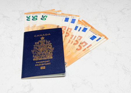 passport and euro money on white marble background, travel and tourism conceptの写真素材