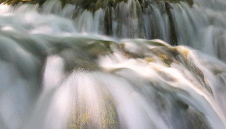 Long exposure of a waterfall flowing through the woods, motion blur.の写真素材