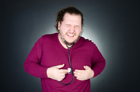 Heart attack. The overweight guy.の写真素材
