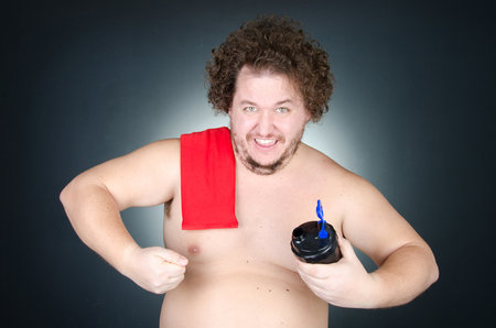 The overweight guy. Funny bodybuilding. Health, sports and diet.の写真素材