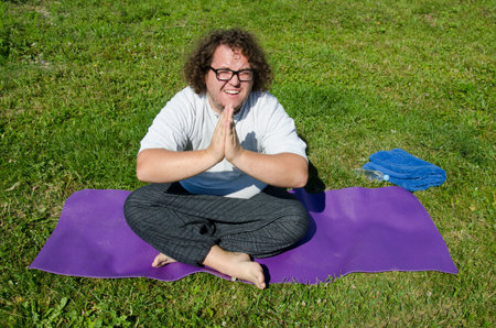 Funny fat man and yoga.の写真素材
