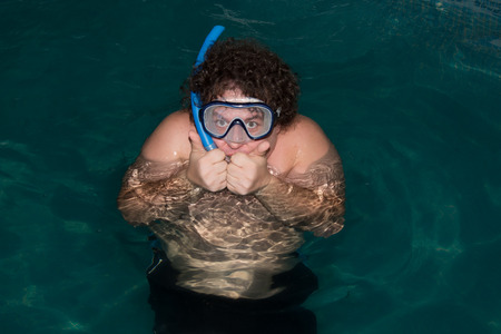 Funny guy in the mask and in the pool.の写真素材
