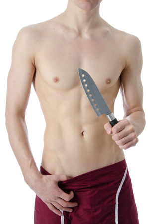 Sexy naked chef. Young cook with a knife. White background.の写真素材