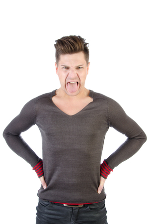 Man shows tongue. Funny guy on a white background.の写真素材