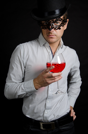 Carnival and the feast. Attractive man in a mask. Holiday and Party. Elegant man in a mask.の写真素材