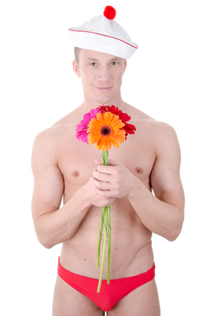 Sexy shirtless sailor with flowers. Naked man in a sailor hat. White background.の写真素材