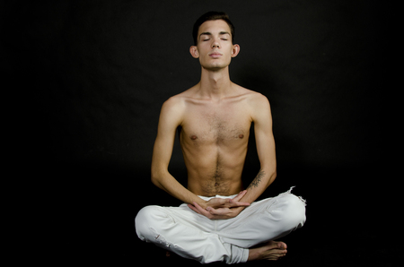 Yoga and calmness. Man in lotus position. Healthy lifestyle and state of mind.の写真素材