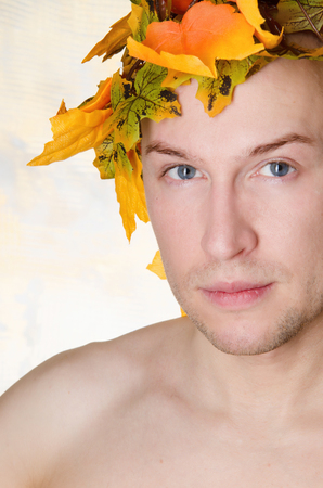 Man in a wreath of maple leaves. Autumn moodの写真素材