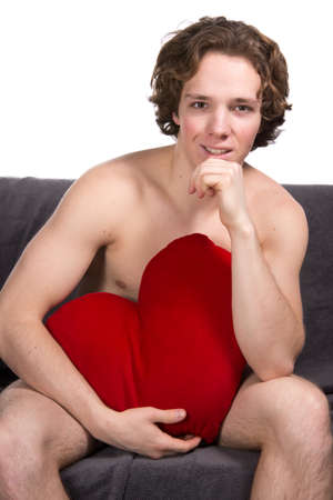Young sexy guy is resting on the sofa.の写真素材