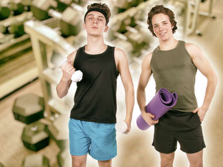Fitness and healthy lifestyle. Two funny young guys. White background.の写真素材