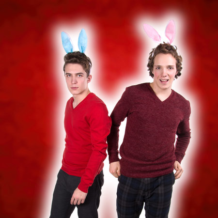 Holidays. Two funny young guys. White background. Cute men.