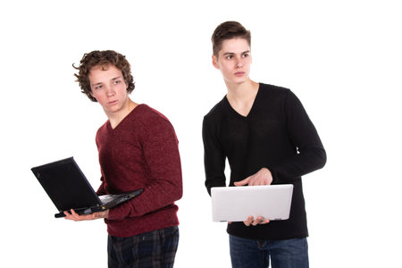 Two attractive students. Laptop. White background.