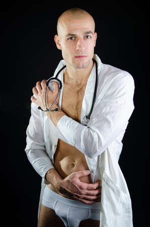 Athletic sexy doctor in a white coat.の写真素材
