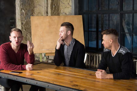 Business and work. A group of young guys in the office.の写真素材