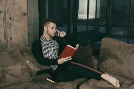 Friends at home reading books.の写真素材