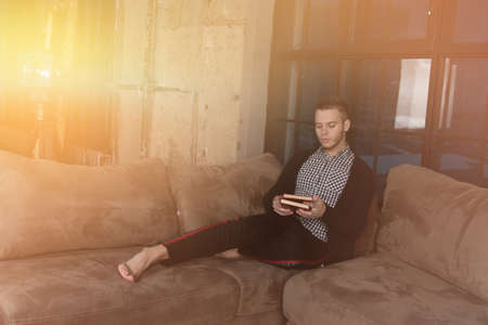 Friends at home reading books.の写真素材