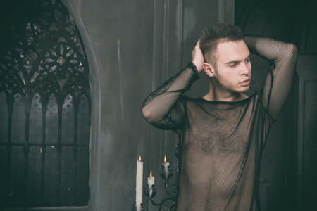 Prayer and sins. Young attractive guy in the church.の写真素材