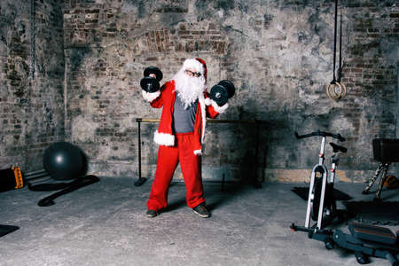 Fitness. Funny Santa Claus and gym.の写真素材