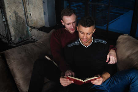 Young attractive couple is resting at home. Gay couple.の写真素材